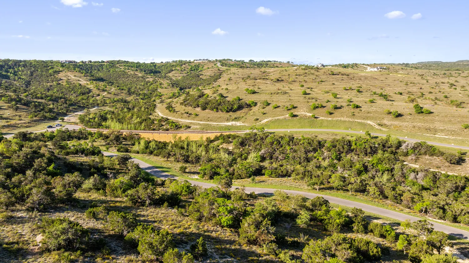 a view of a swimming pool with a yard and lake view