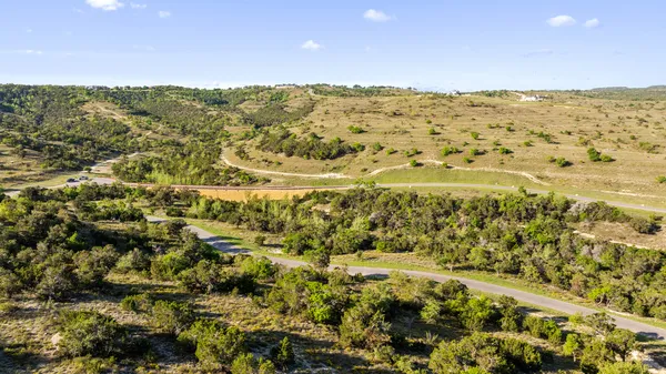 a view of a swimming pool with a yard and lake view