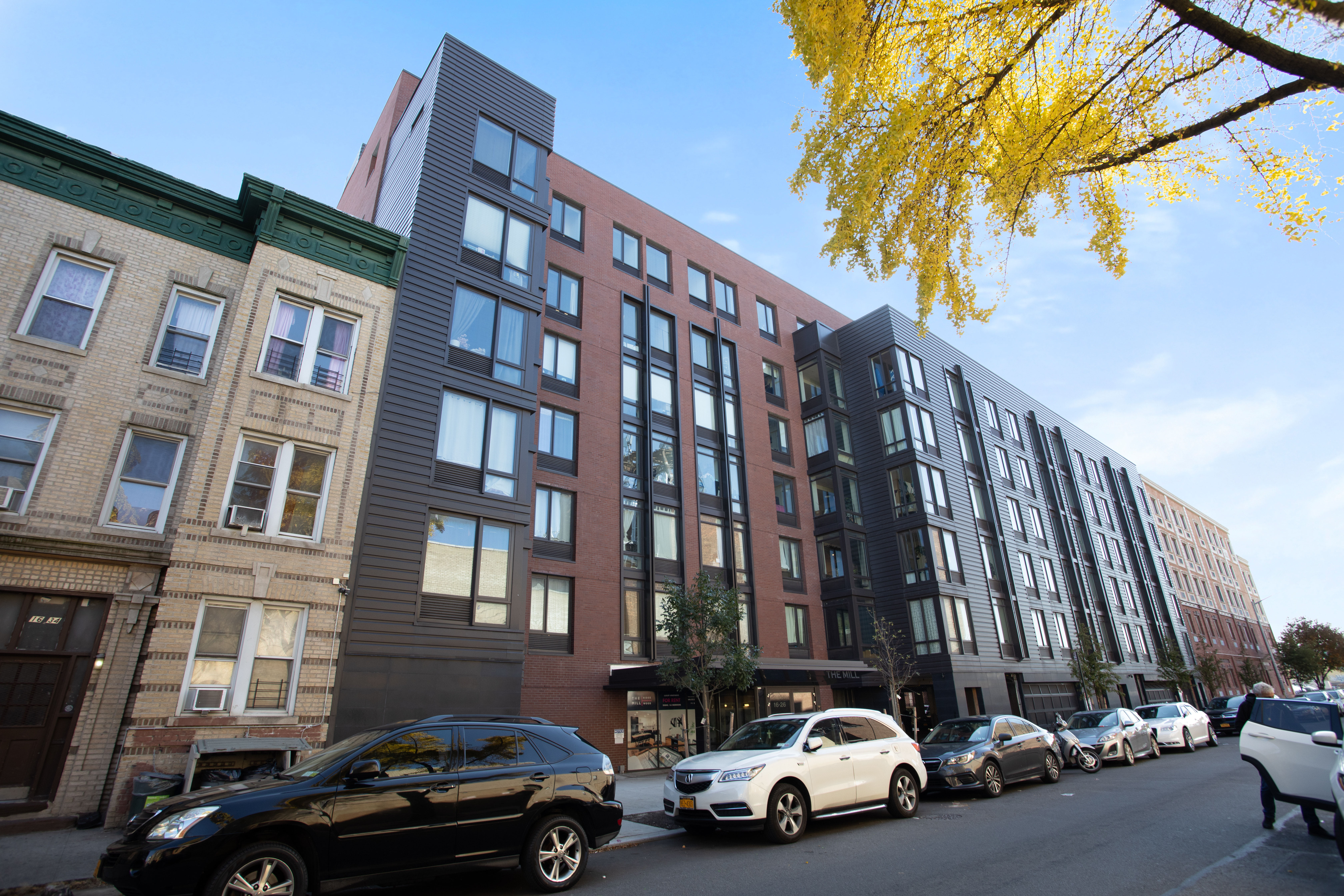 16-26 Madison Street, Unit PHA Queens, NY 11385 - Photo 10 of 16 a view of cars parked in front of a building