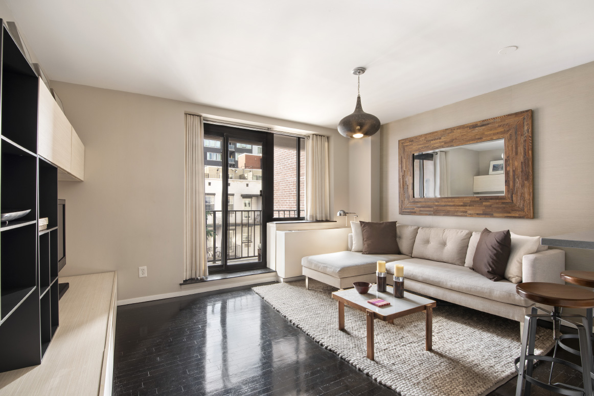 a living room with furniture a window and a chandelier