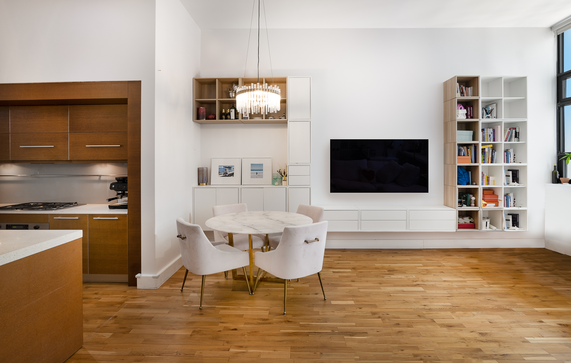 360 Furman Street, Unit 701 Brooklyn, NY 11201 - Photo 2 of 14 a living room with stainless steel appliances kitchen island granite countertop a sink and a flat screen tv