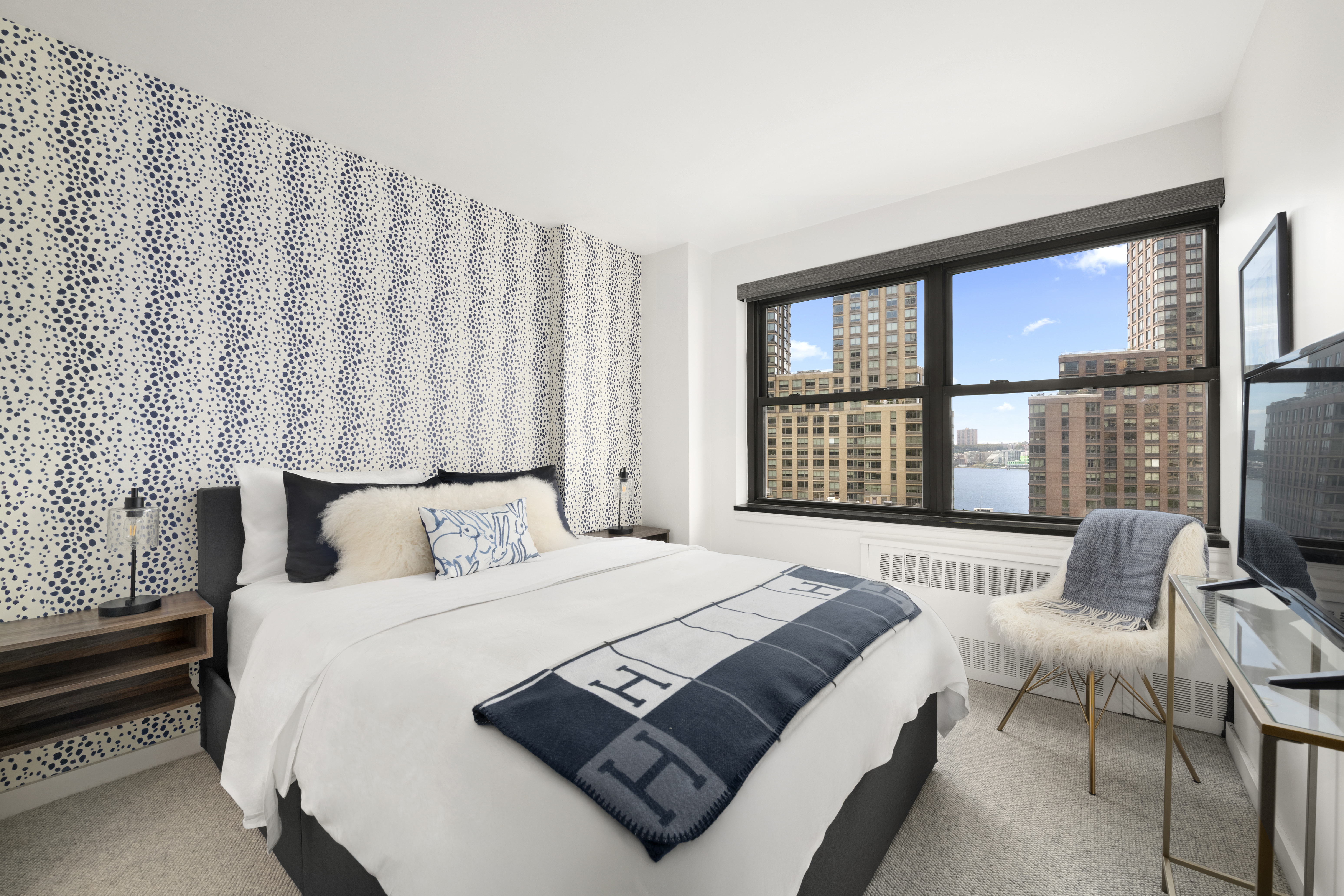 185 West End Avenue, Unit 11P Manhattan, NY 10023 - Photo 5 of 10 a bedroom with a bed and a large window