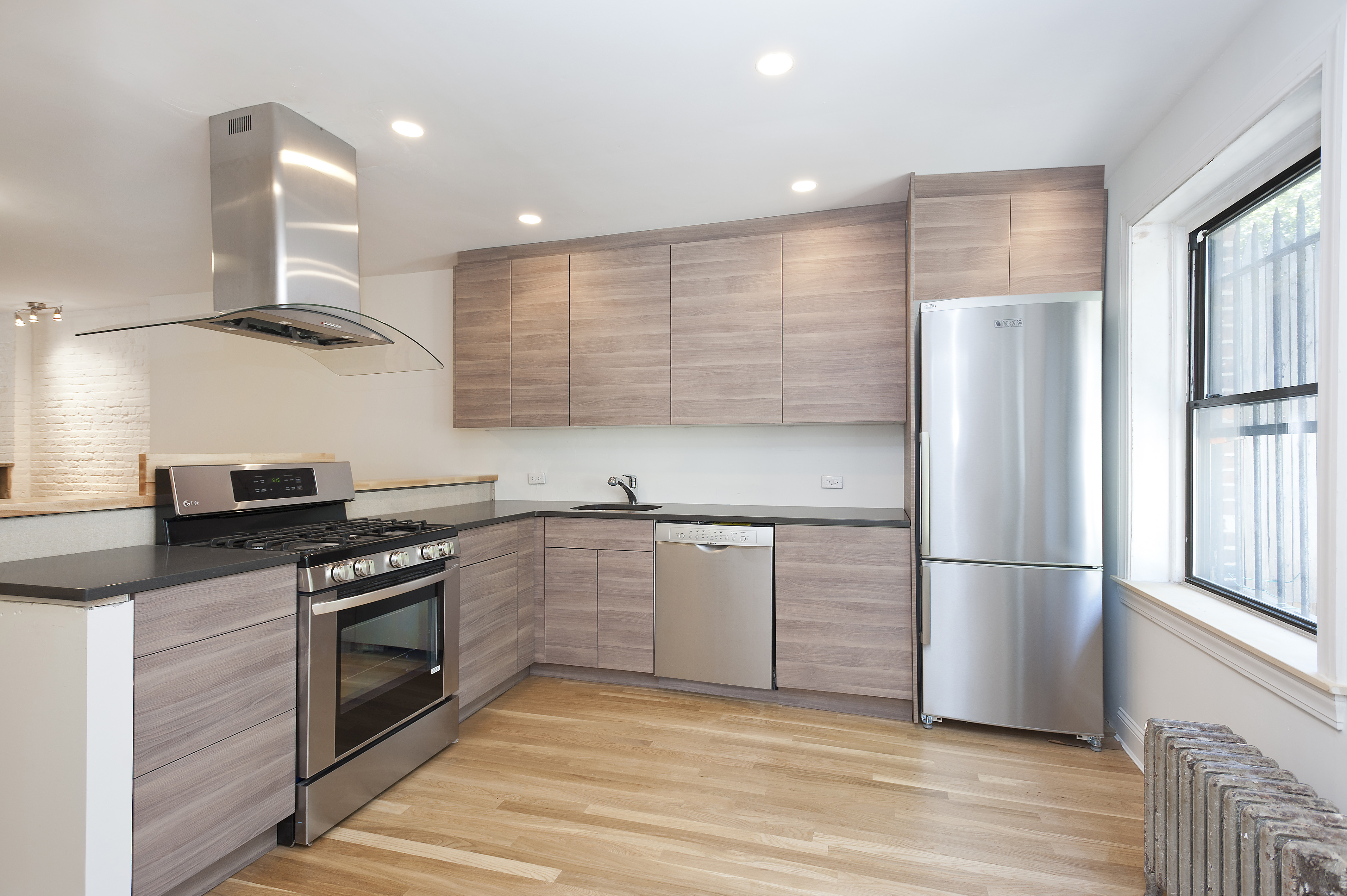 68 Berkeley Place, Unit 1 Brooklyn, NY 11217 - Photo 2 of 7 a kitchen with stainless steel appliances granite countertop a refrigerator a stove and a sink