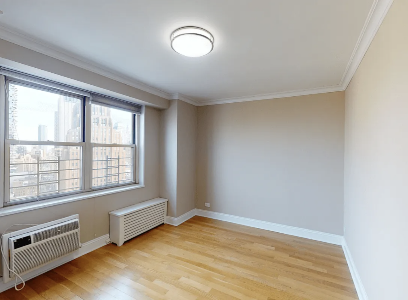 40 Harrison Street, Unit 24H Manhattan, NY 10013 - Photo 15 of 17 an empty room with wooden floor and windows