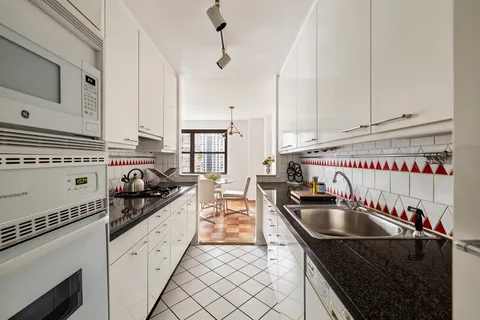 a kitchen that has a sink and a stove