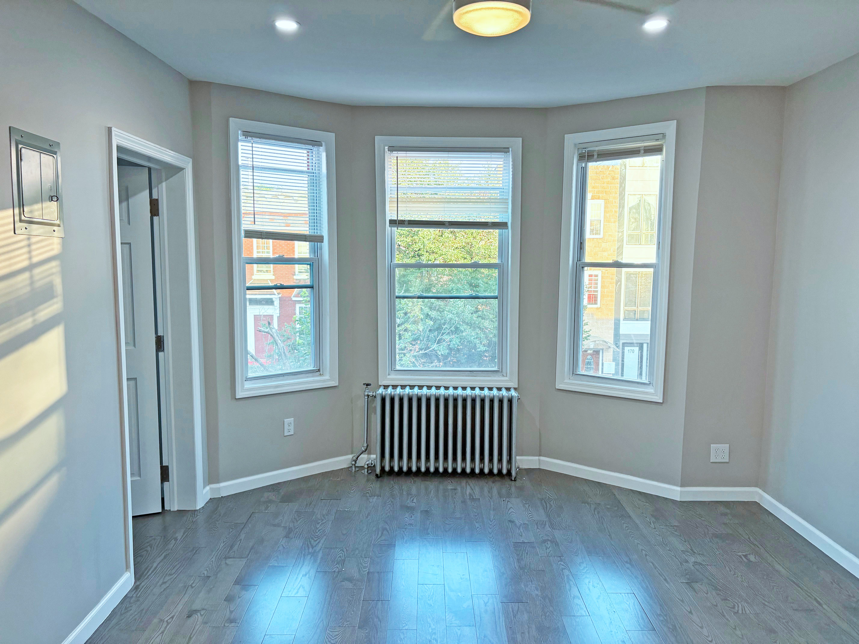 179 Covert Street, Unit 3 Brooklyn, NY 11207 - Photo 2 of 14 an empty room with wooden floor and windows