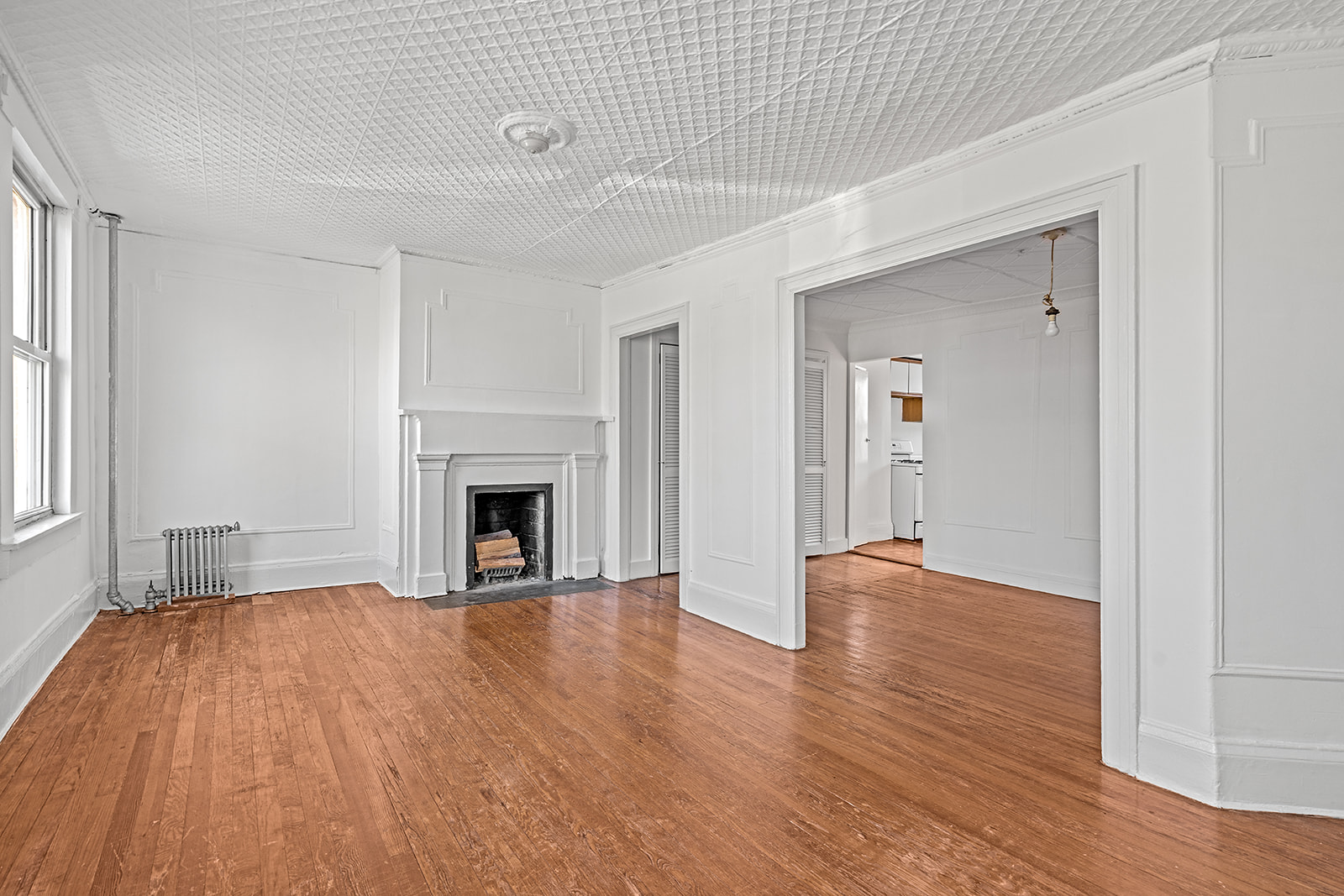44 Butler Street Brooklyn, NY 11231 - Photo 13 of 22 a view of an empty room with wooden floor fireplace and a window