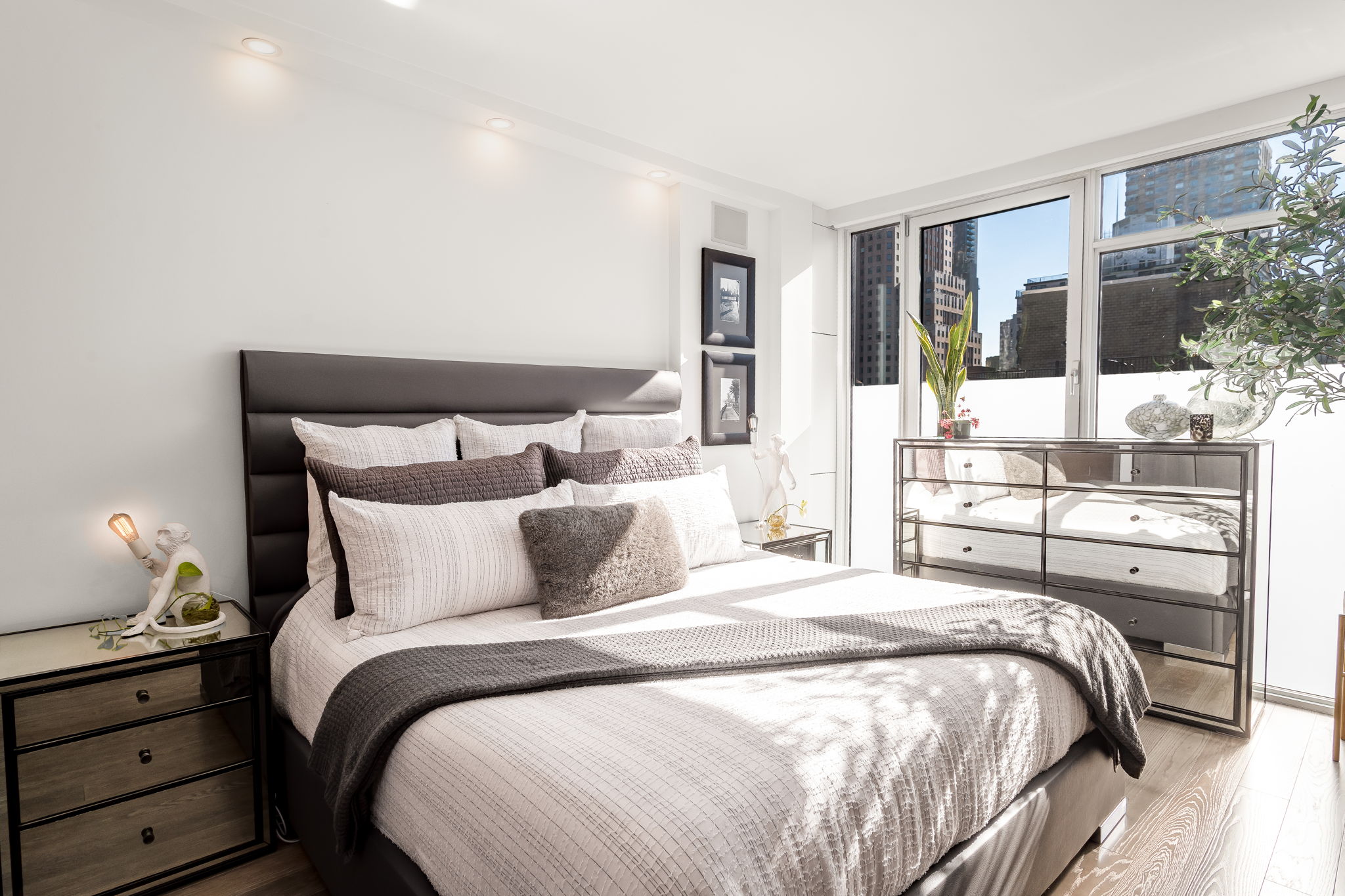 350 West 53rd Street, Unit PHB Manhattan, NY 10019 - Photo 12 of 34 a bedroom with a bed and large window