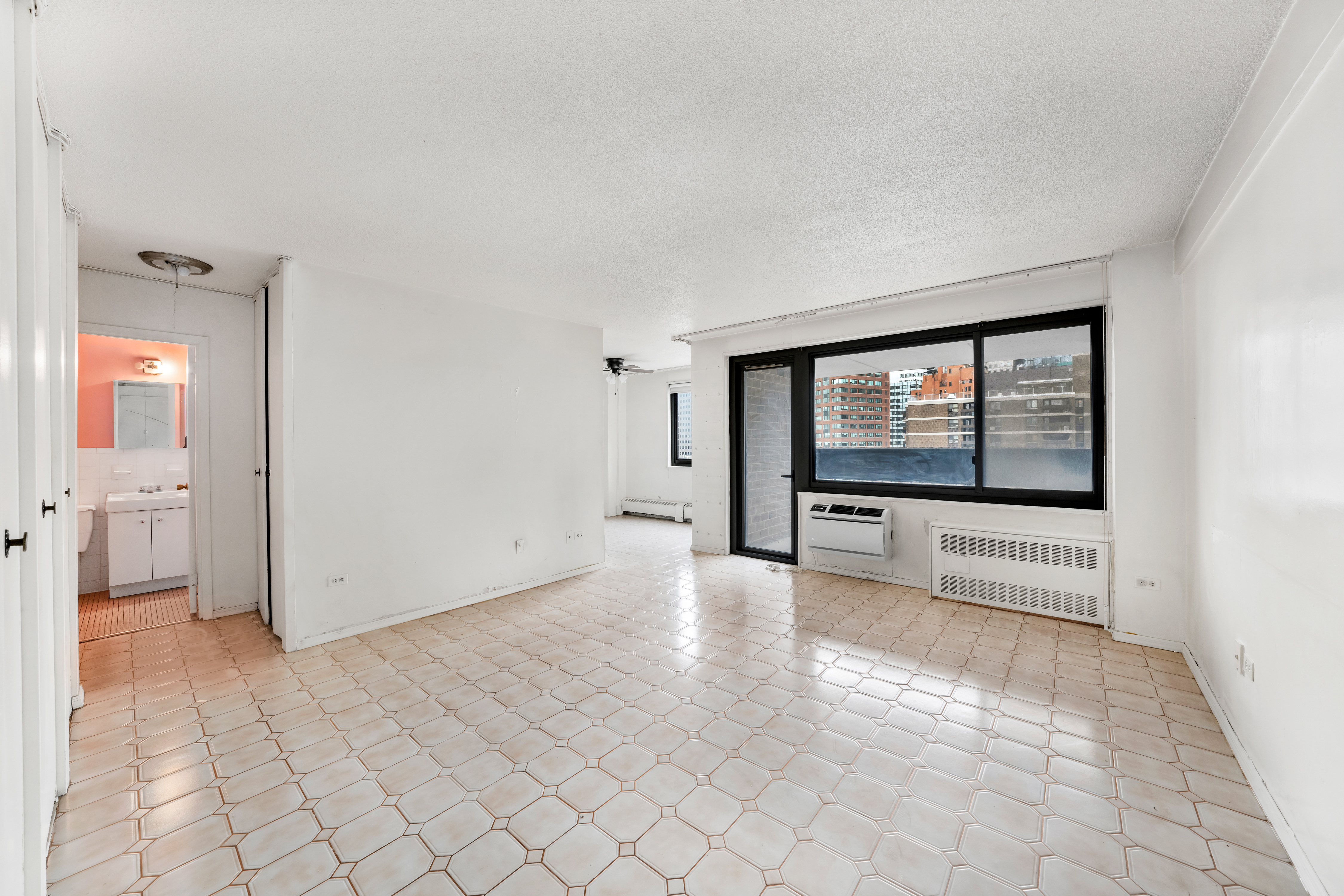 90 Gold Street, Unit 26A Manhattan, NY 10038 - Photo 2 of 6 a view of an empty room and window