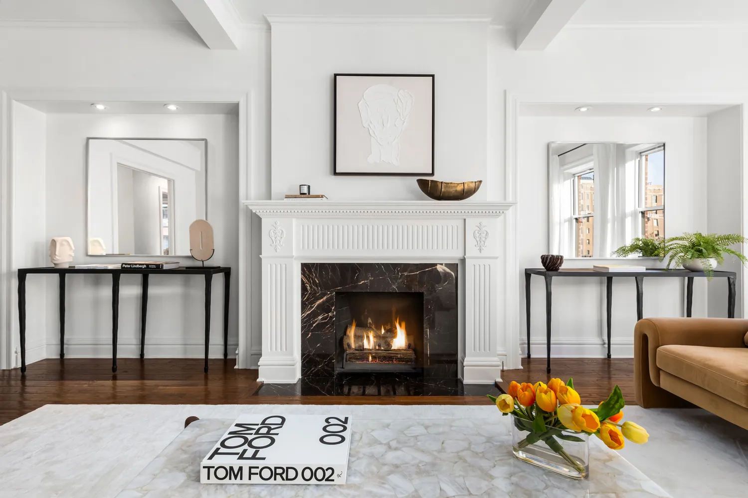 a living room with furniture a fireplace and kitchen view