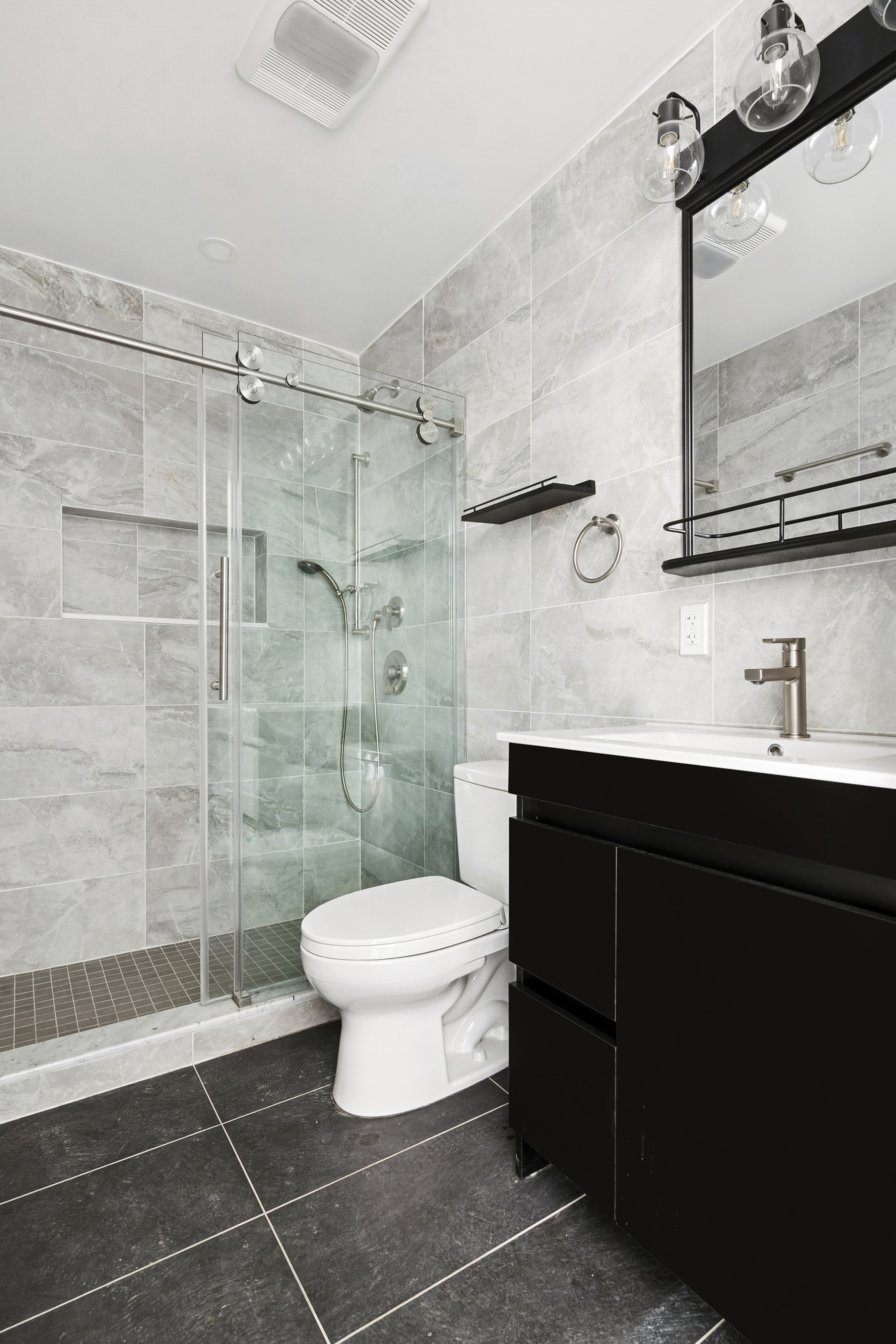 176 12th Street, Unit 2 Brooklyn, NY 11215 - Photo 8 of 10 a bathroom with a sink toilet a mirror and shower