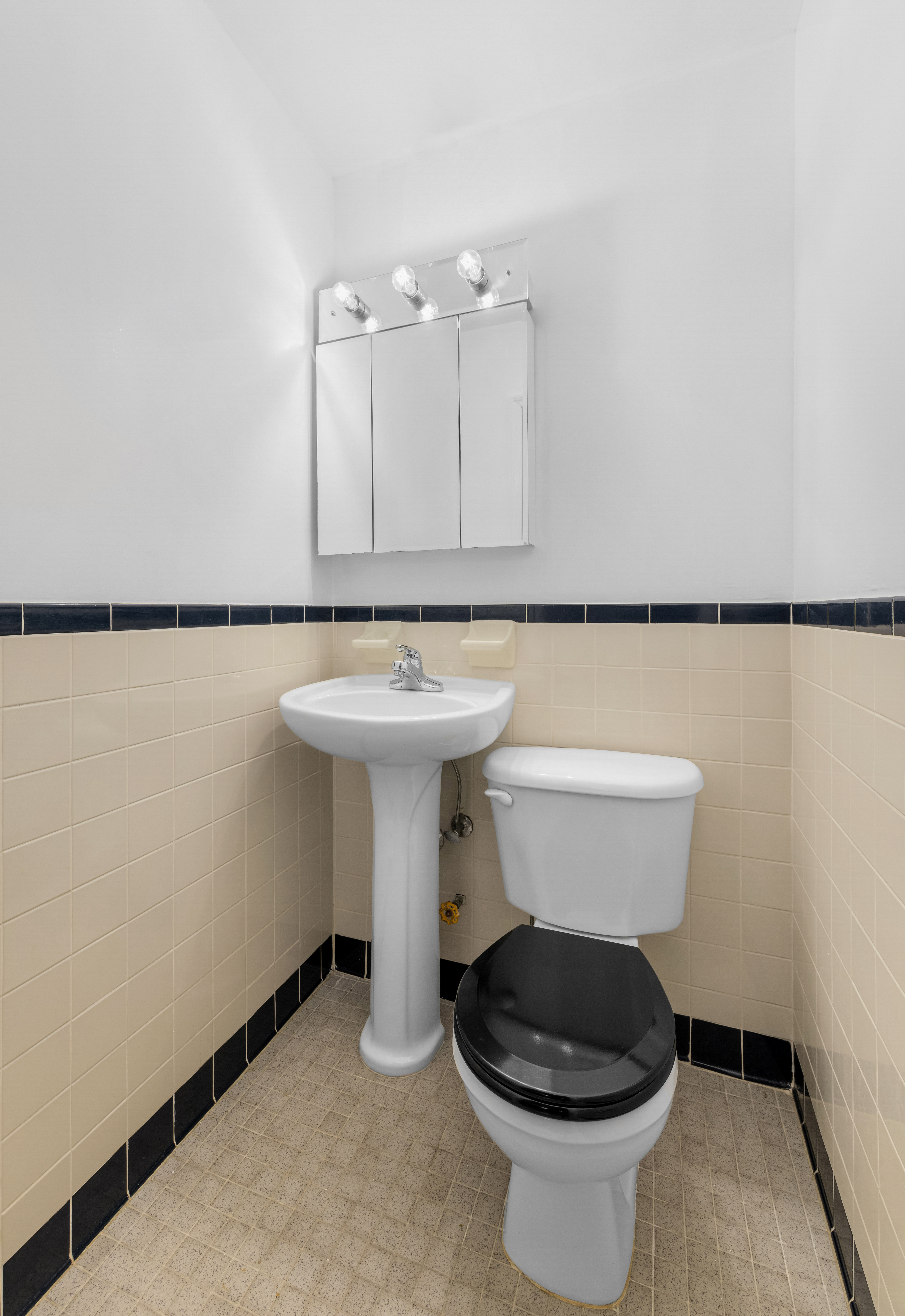 231 West 148th Street, Unit 2L Manhattan, NY 10039 - Photo 9 of 15 a bathroom with a sink toilet and a mirror