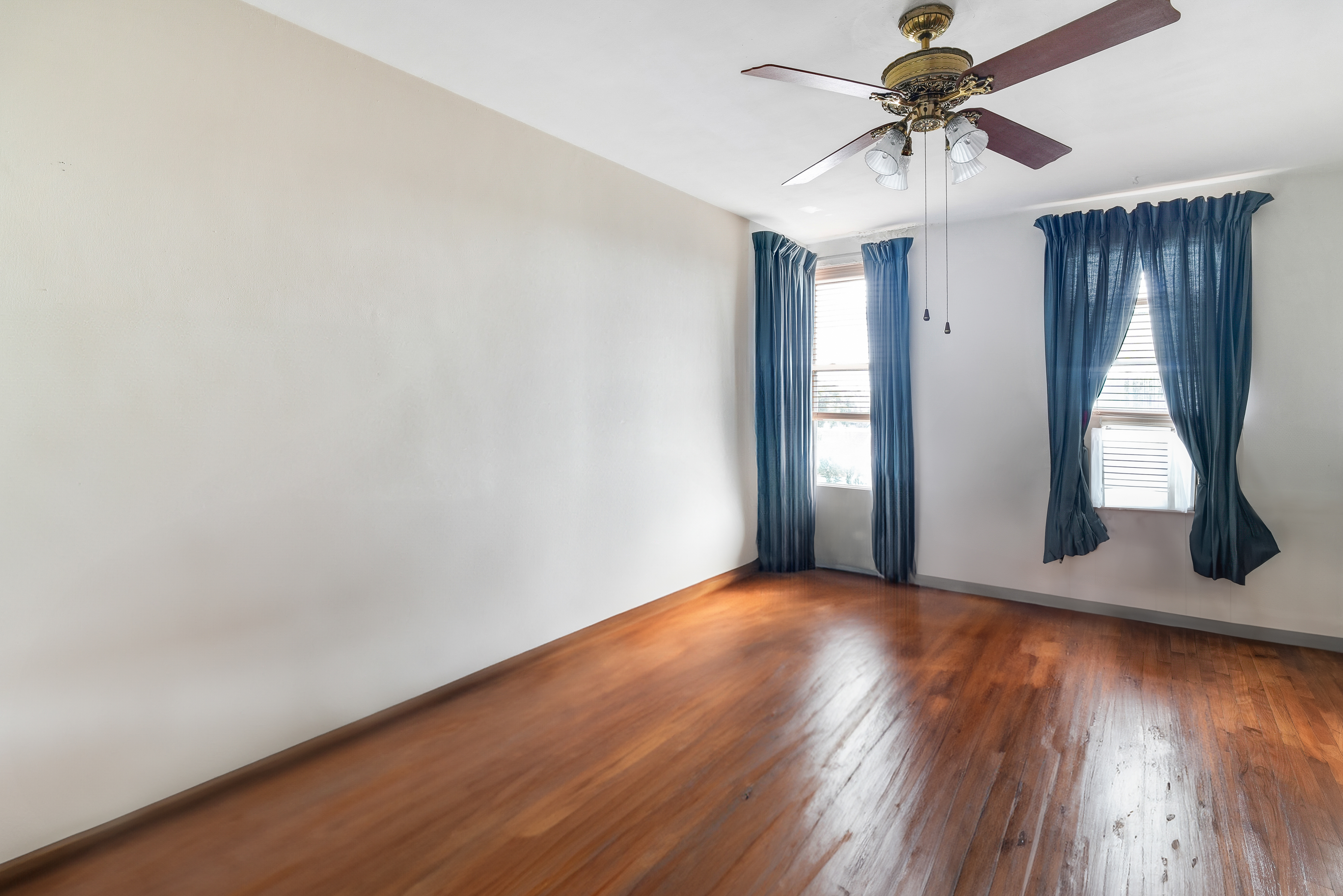 9801 Shore Road, Unit 3E Brooklyn, NY 11209 - Photo 7 of 9 a view of a livingroom with wooden floor and a ceiling fan