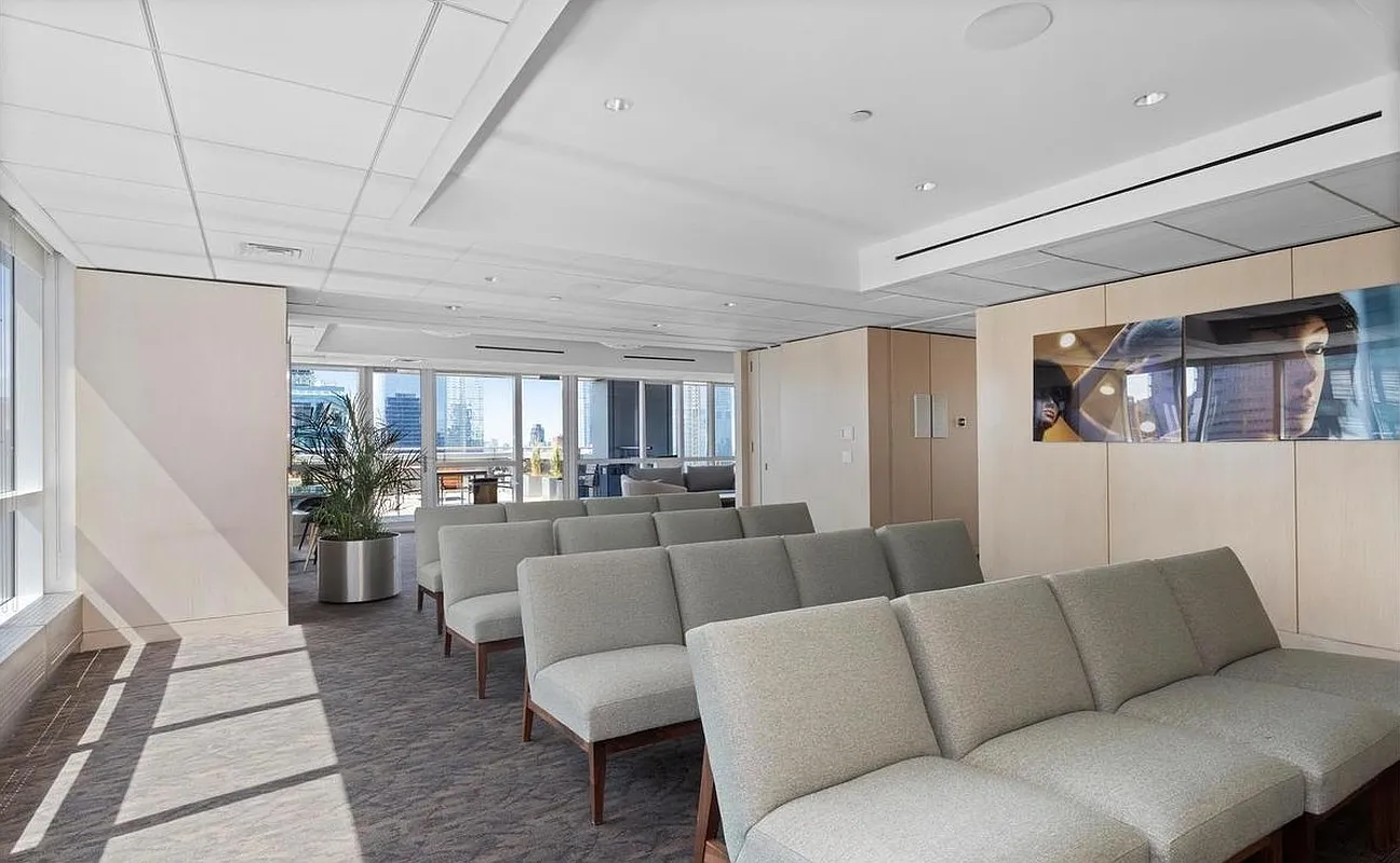 350 West 42nd Street, Unit 8H Manhattan, NY 10036 - Photo 9 of 11 a living room with furniture kitchen view and a window