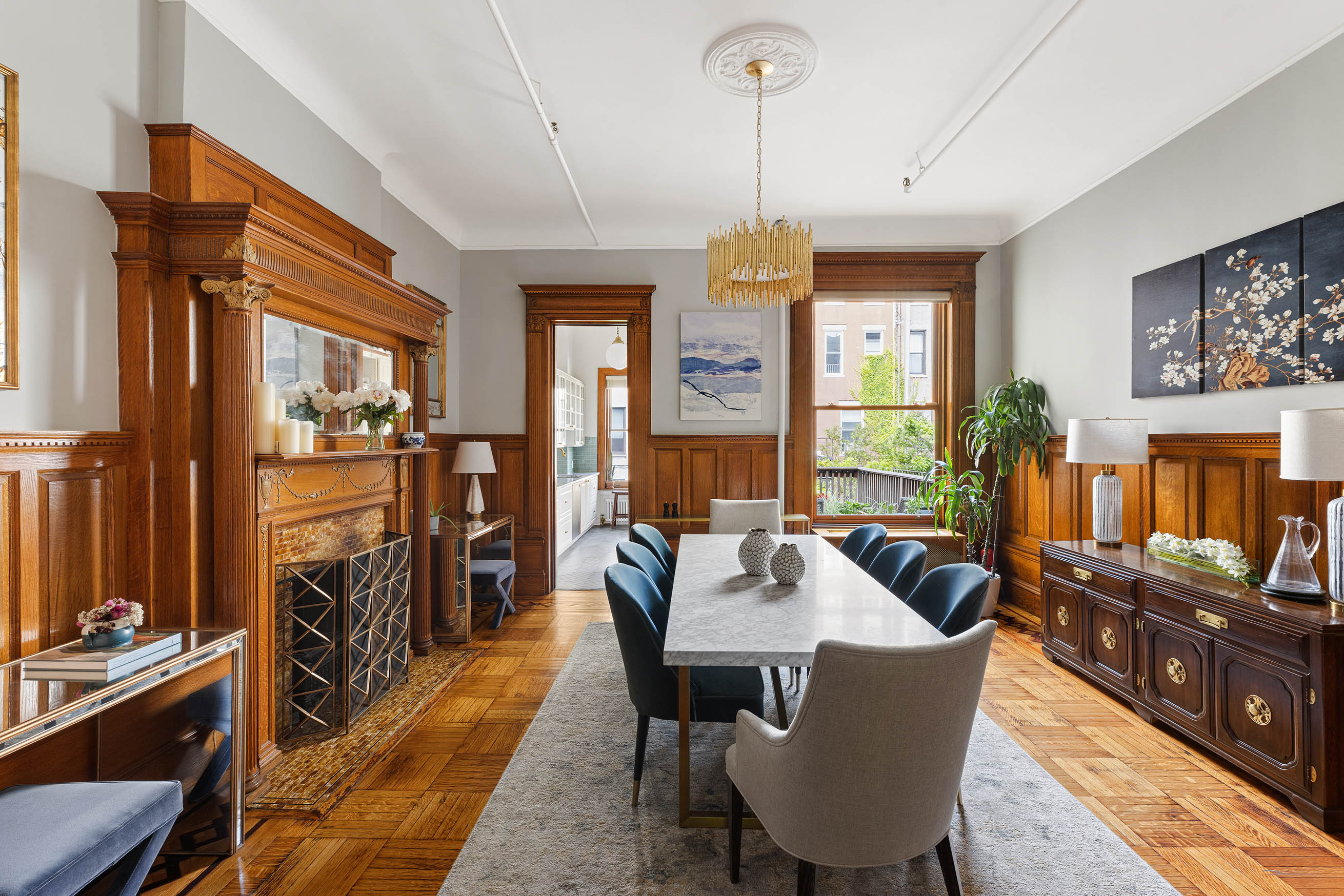 89 West 119th Street Manhattan, NY 10026 - Photo 3 of 22 a view of a dining room with furniture a chandelier and wooden floor