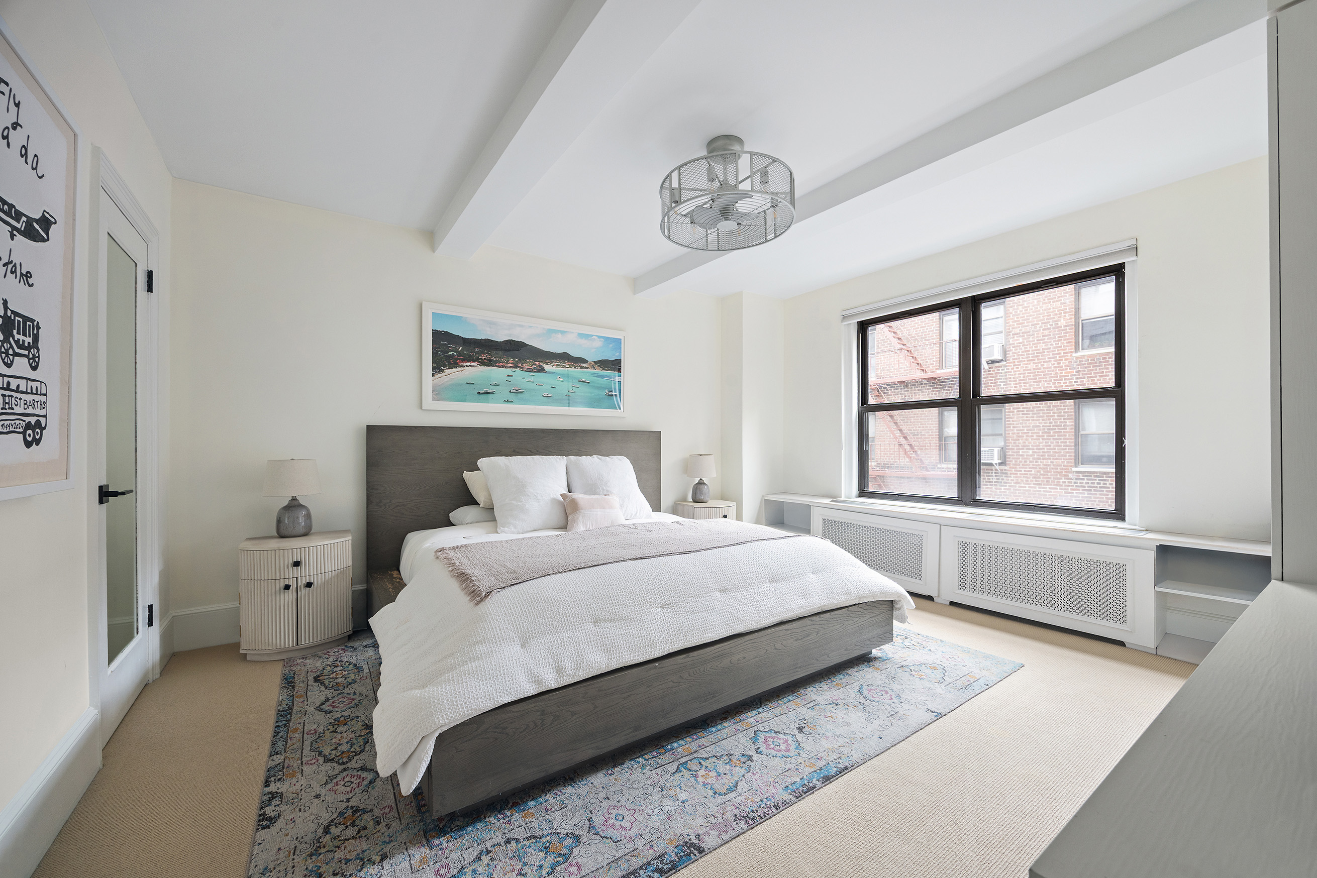 325 East 79th Street, Unit 6C Manhattan, NY 10075 - Photo 9 of 17 a bedroom with a large bed and a window