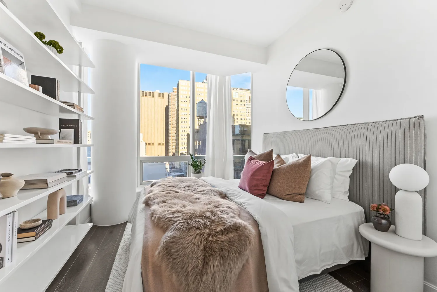 a bedroom with a large bed and a window