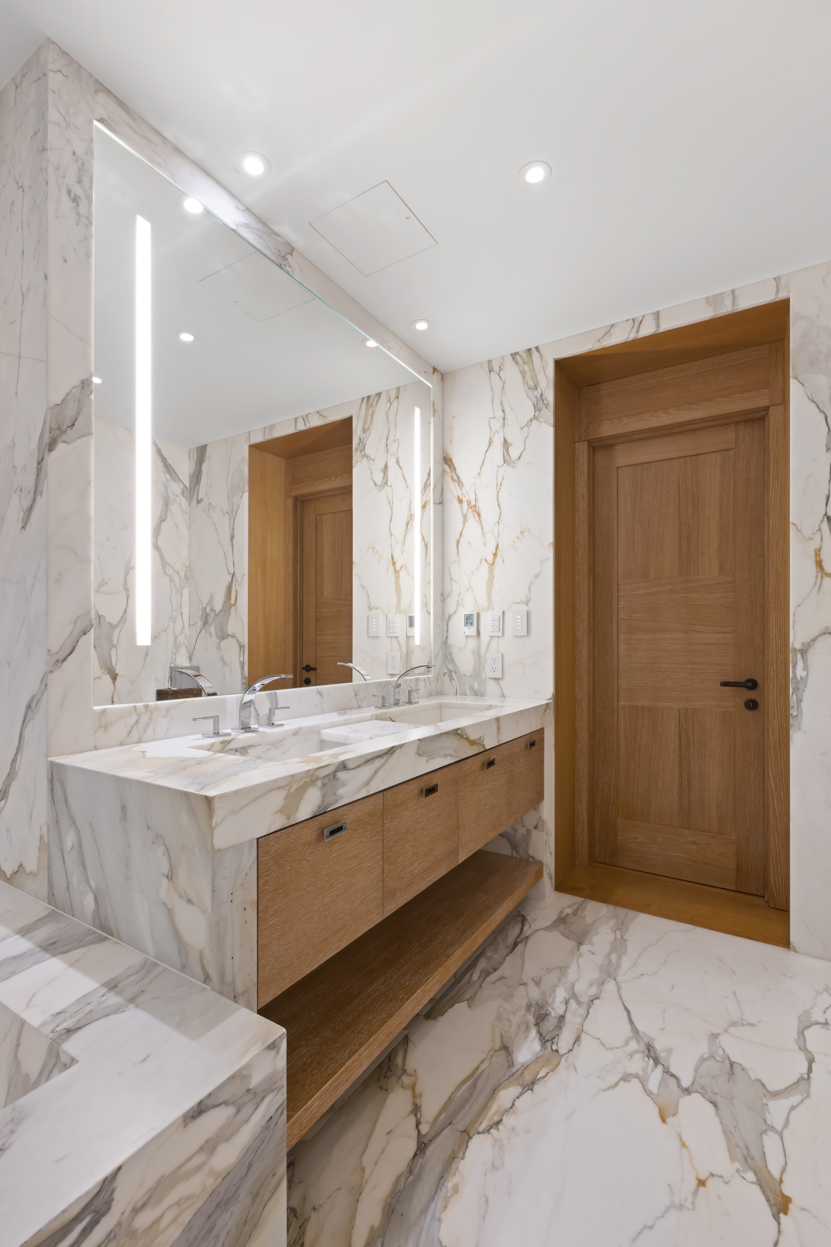 45 East 74th Street Manhattan, NY 10021 - Photo 18 of 33 a bathroom with a granite countertop sink a mirror and a bathtub
