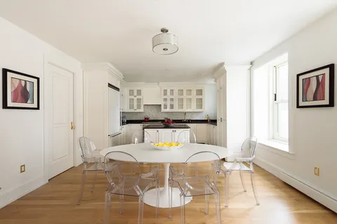 a living room with furniture and kitchen view