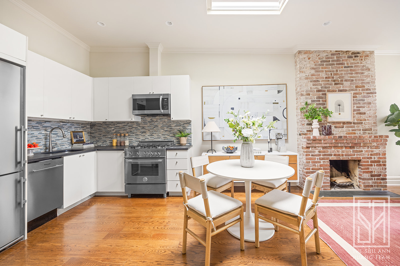 307 7th Street, Unit 4L Brooklyn, NY 11215 - Photo 3 of 15 a kitchen with stainless steel appliances kitchen island granite countertop a stove top oven a sink a dining table and chairs