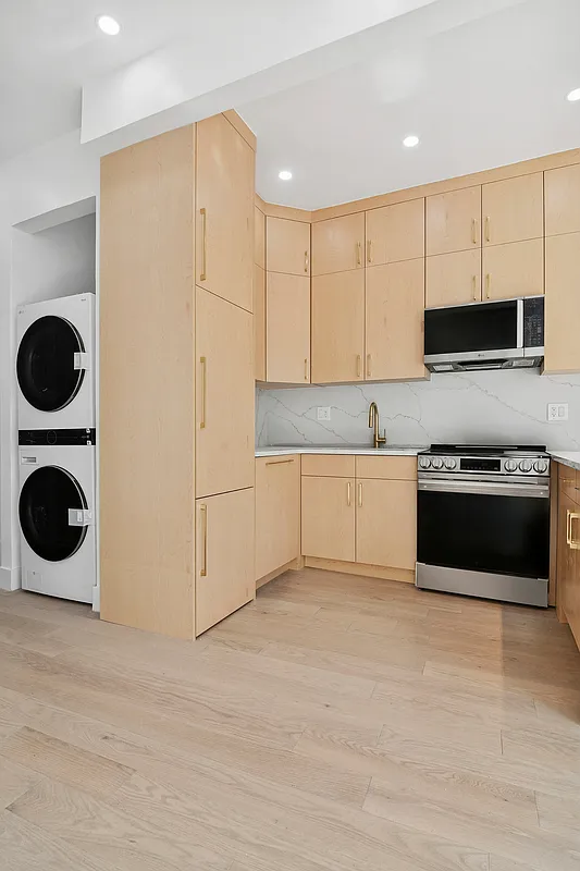 457 Bergen Street, Unit 2F Brooklyn, NY 11217 - Photo 5 of 12 a kitchen with a stove top oven and cabinets