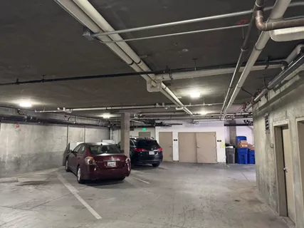 a view of parking garage with cars