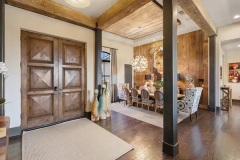 a open kitchen with stainless steel appliances kitchen island granite countertop a table and chairs in it