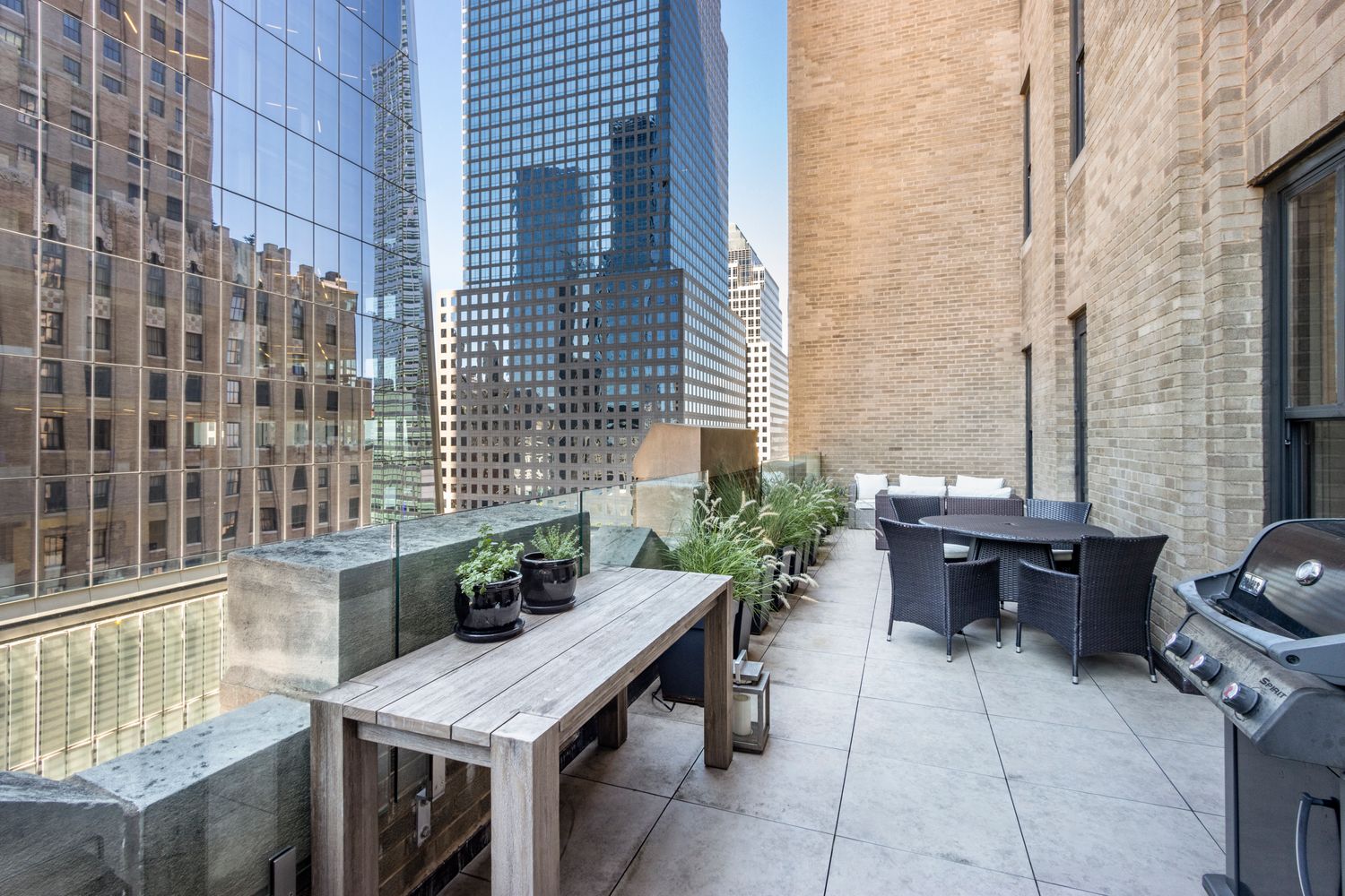 100 Barclay Street, Unit 14M Manhattan, NY 10007 - Photo 5 of 19 a balcony with furniture and potted plants