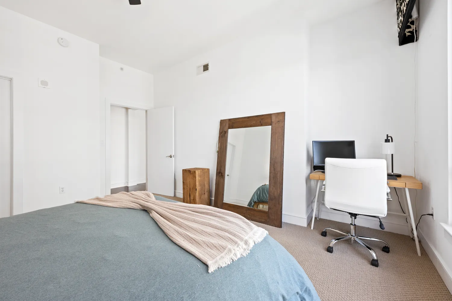 a bedroom with a bed and a chair