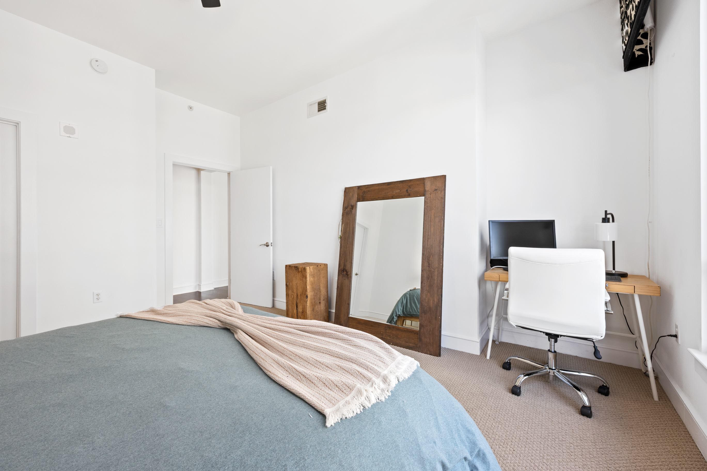 222 12th Street Northeast Atlanta, GA 30309 - Photo 18 of 56 a bedroom with a bed and a chair