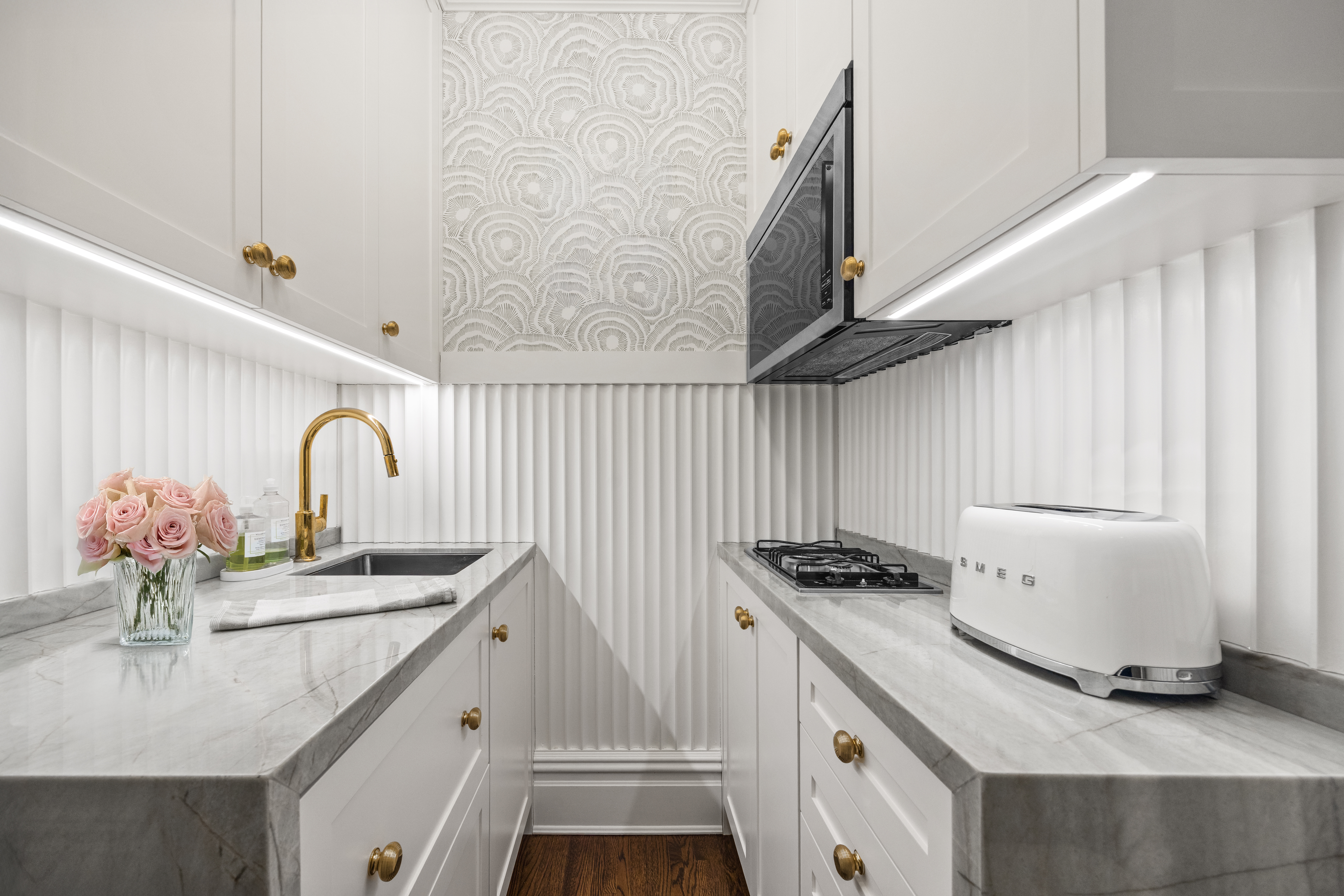 23 East 74th Street, Unit 7E Manhattan, NY 10021 - Photo 4 of 8 a kitchen with stainless steel appliances granite countertop a sink stove and cabinets