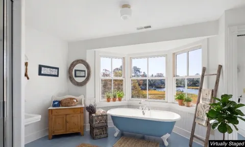 a view of a lake with lawn chairs