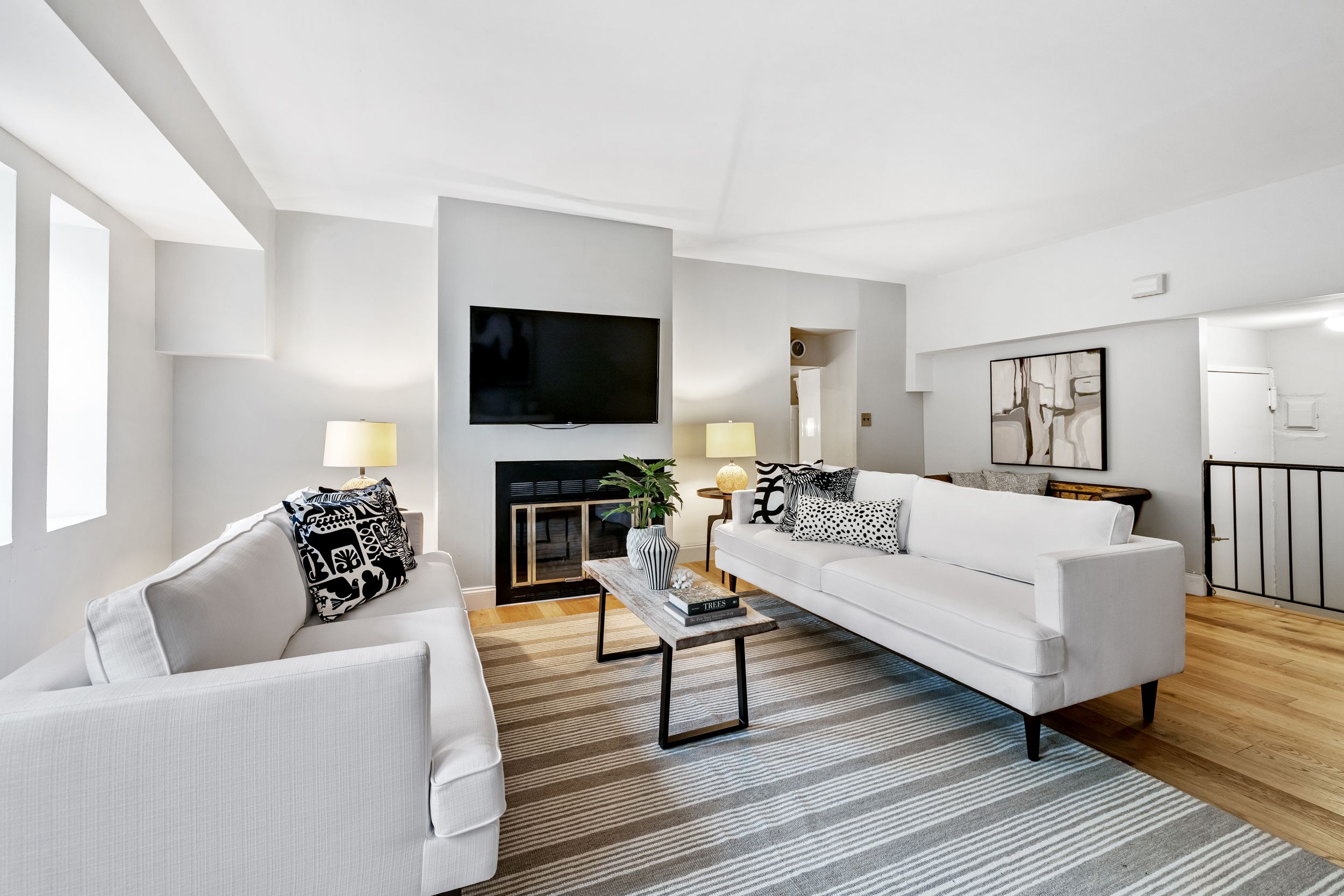 248 East 31st Street, Unit 4A Manhattan, NY 10016 - Photo 3 of 14 a living room with fireplace furniture and a flat screen tv