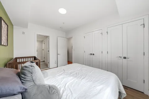 a bedroom with a bed and a closet