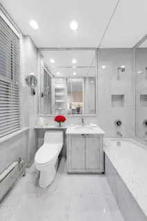 a bathroom with a sink mirror toilet and bathtub