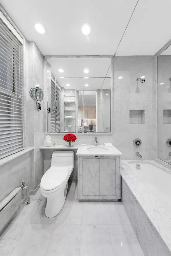 a bathroom with a sink mirror toilet and bathtub