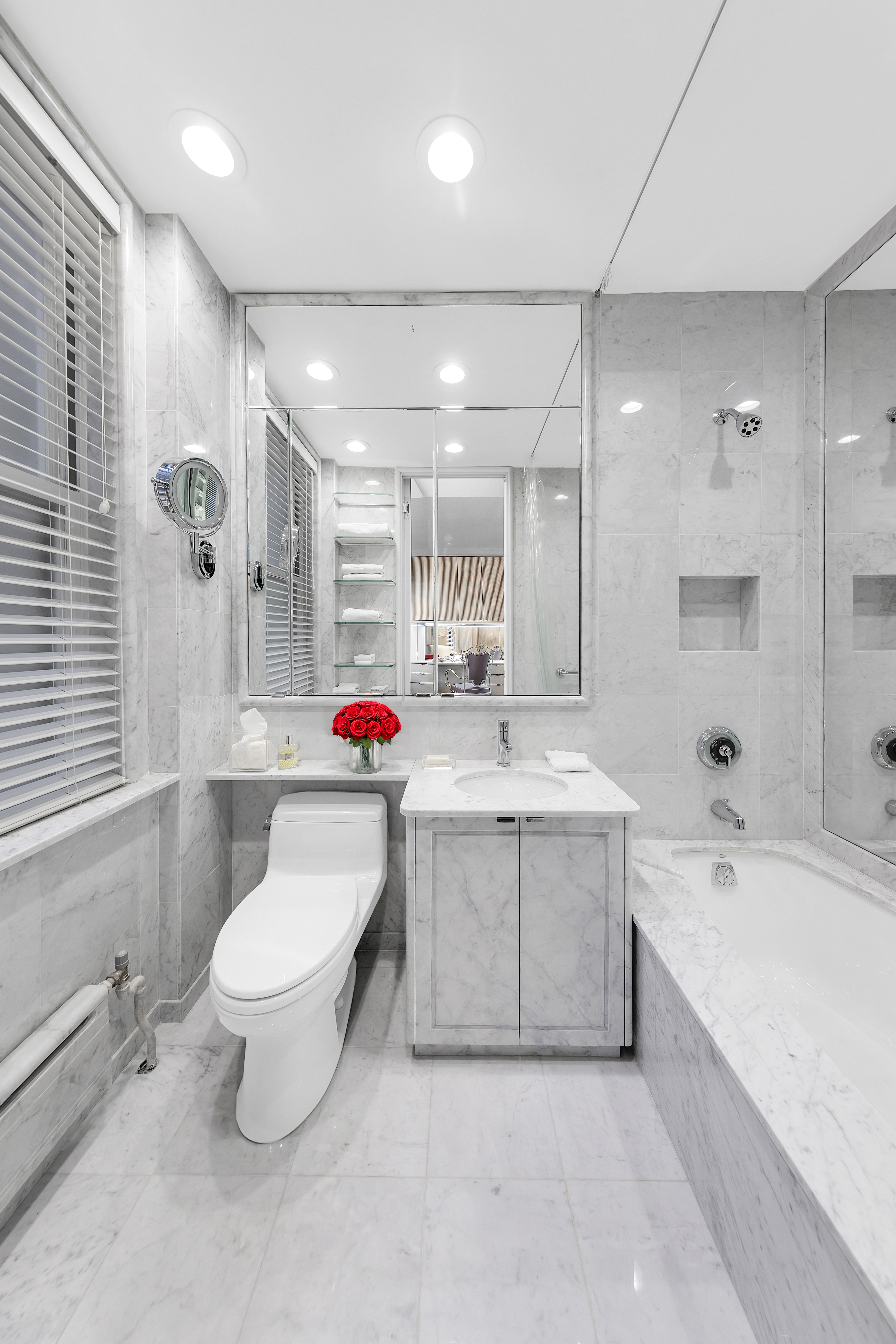 465 Park Avenue, Unit 9F Manhattan, NY 10022 - Photo 11 of 13 a bathroom with a sink mirror toilet and bathtub