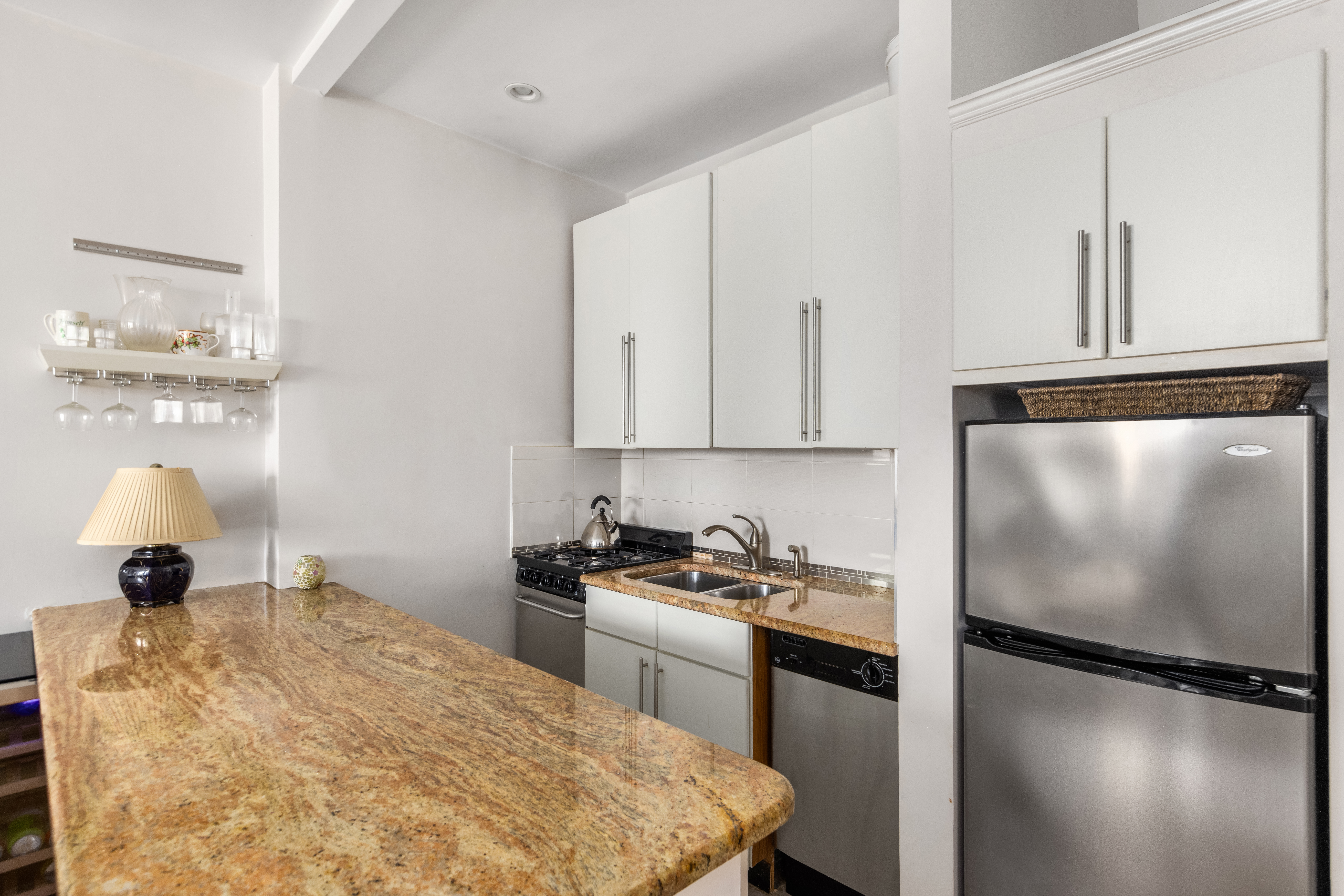 11 Charlton Street, Unit 2C Manhattan, NY 10014 - Photo 5 of 7 a kitchen with a refrigerator and a stove top oven