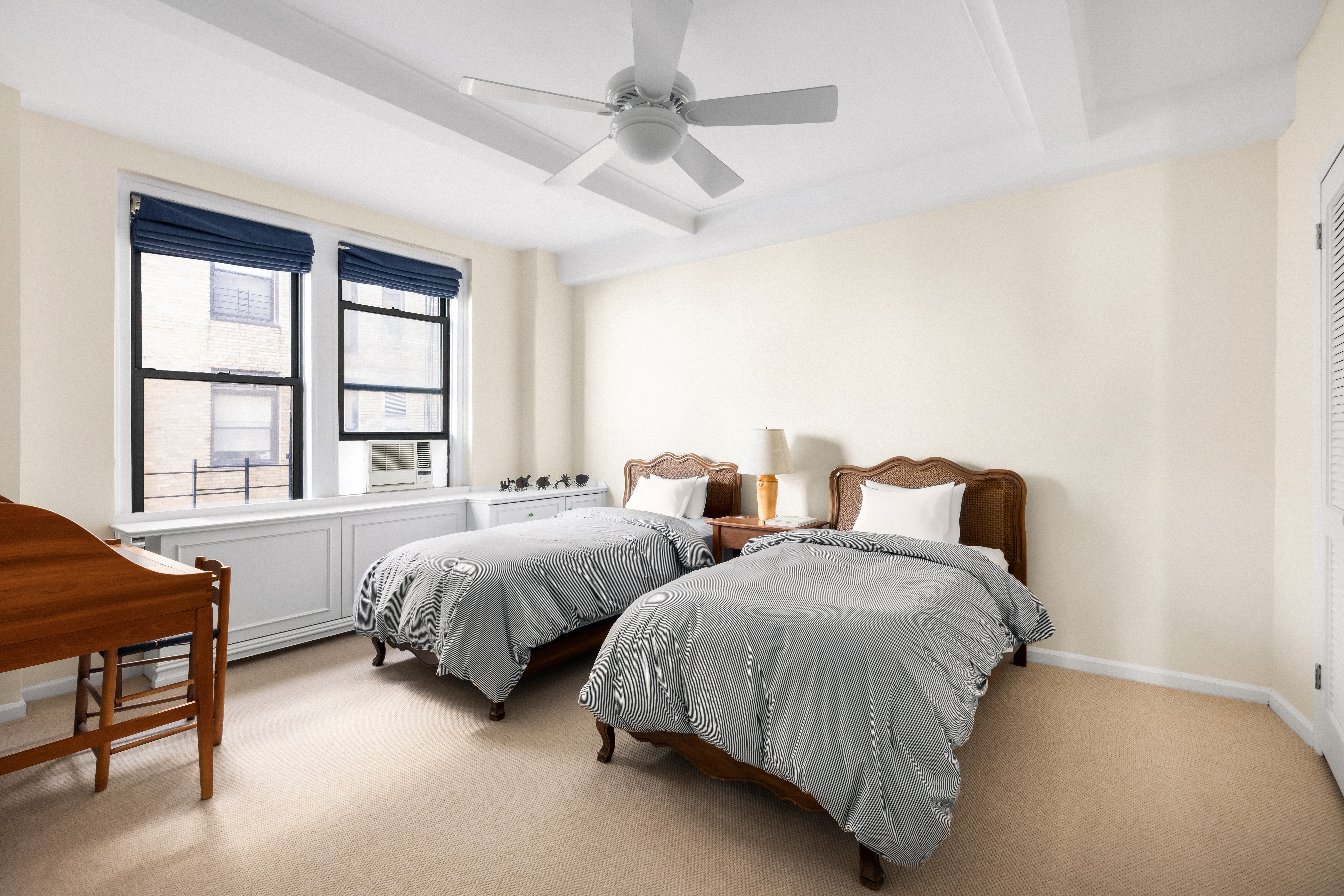 33 Riverside Drive, Unit 13AB Manhattan, NY 10023 - Photo 13 of 19 a spacious bedroom with two beds and a window