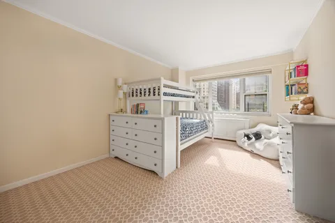 a view of a bedroom with furniture and windows