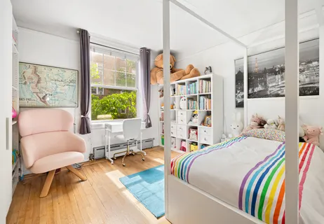 a bedroom with a bed and a large window