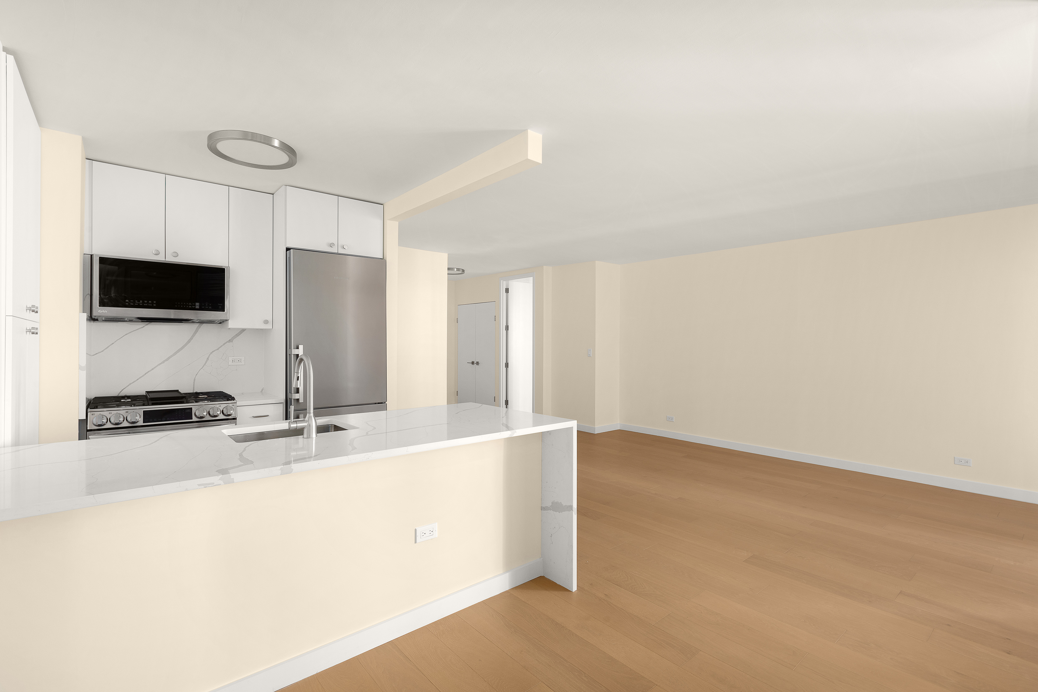 161 West 61st Street, Unit 5C Manhattan, NY 10023 - Photo 9 of 30 a kitchen with a sink a stove and a refrigerator