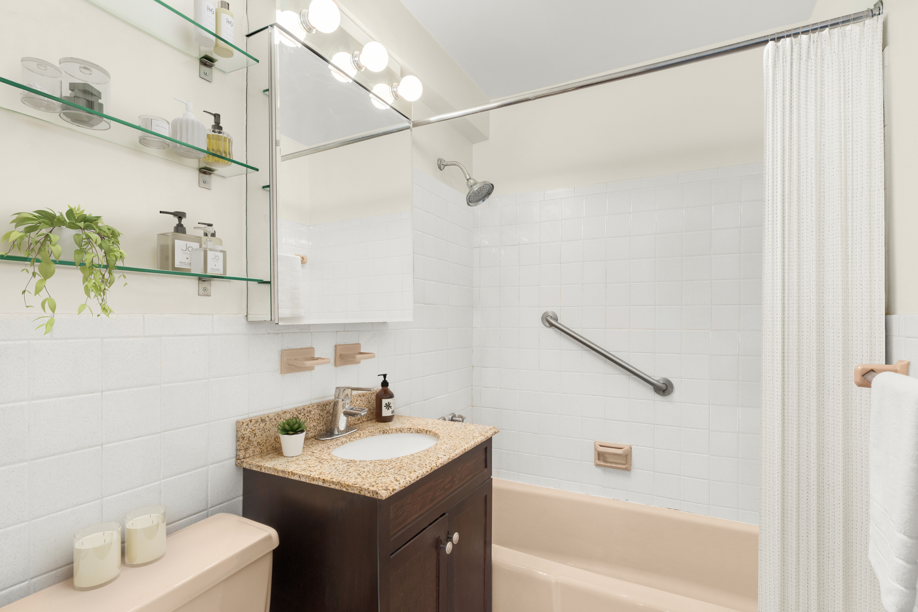 333 East 66th Street, Unit 3B Manhattan, NY 10065 - Photo 6 of 7 a bathroom with a sink toilet and shower