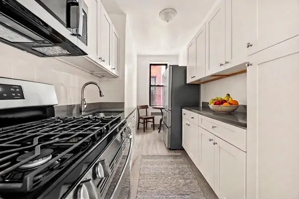 a kitchen with stainless steel appliances granite countertop a stove and a sink