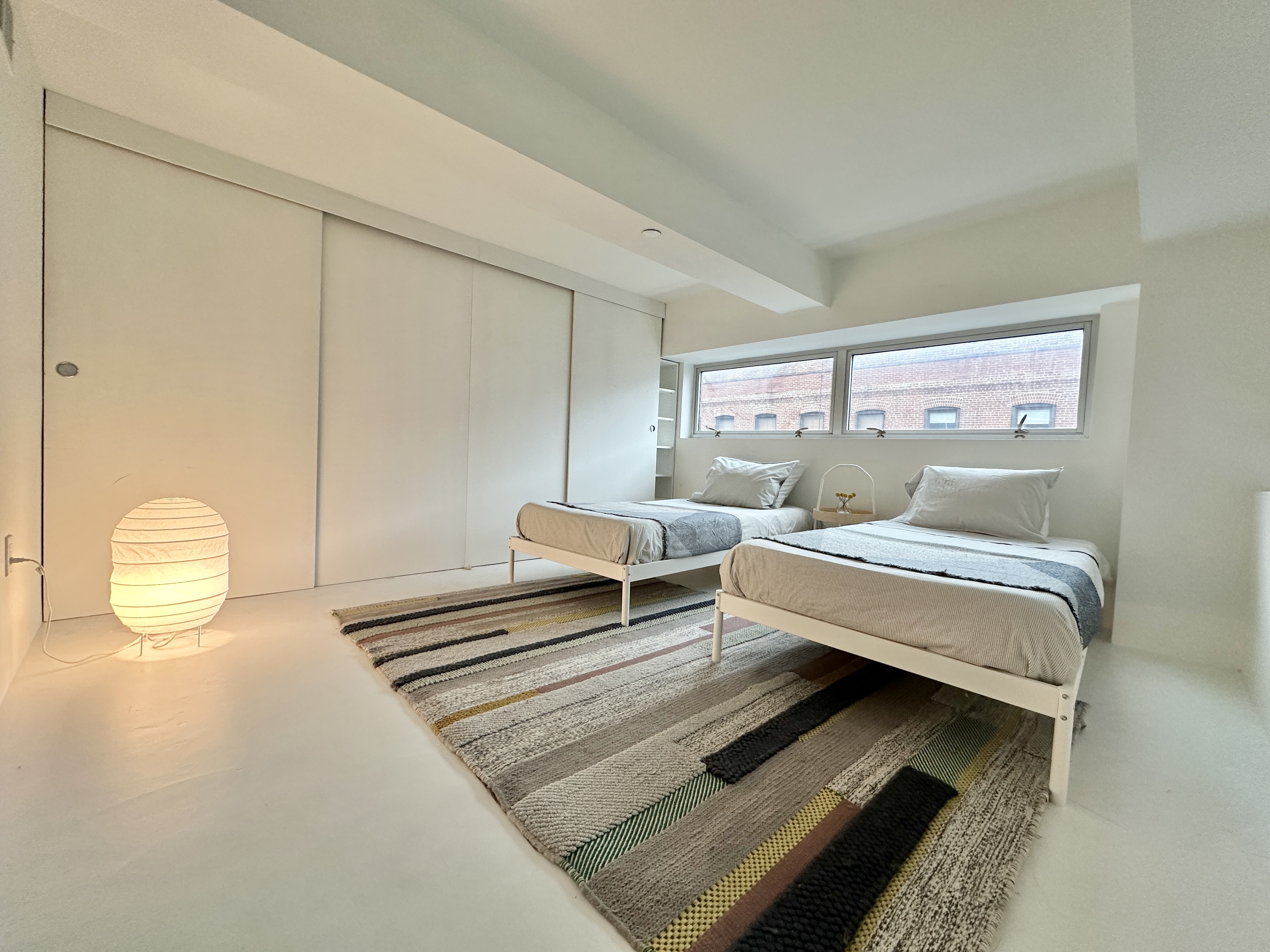 100 North 3rd Street, Unit 3E Brooklyn, NY 11249 - Photo 8 of 15 a bedroom with a bed and window