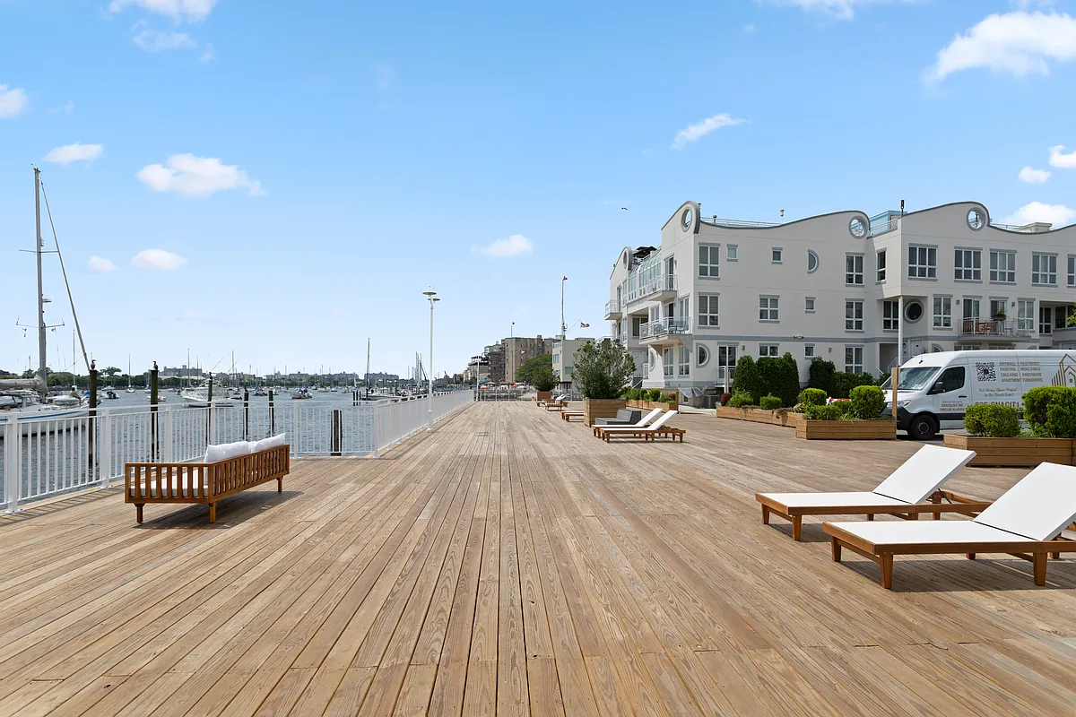 3112 Emmons Avenue, Unit 3120A2 Brooklyn, NY 11235 - Photo 13 of 14 a swimming pool with outdoor seating and yard