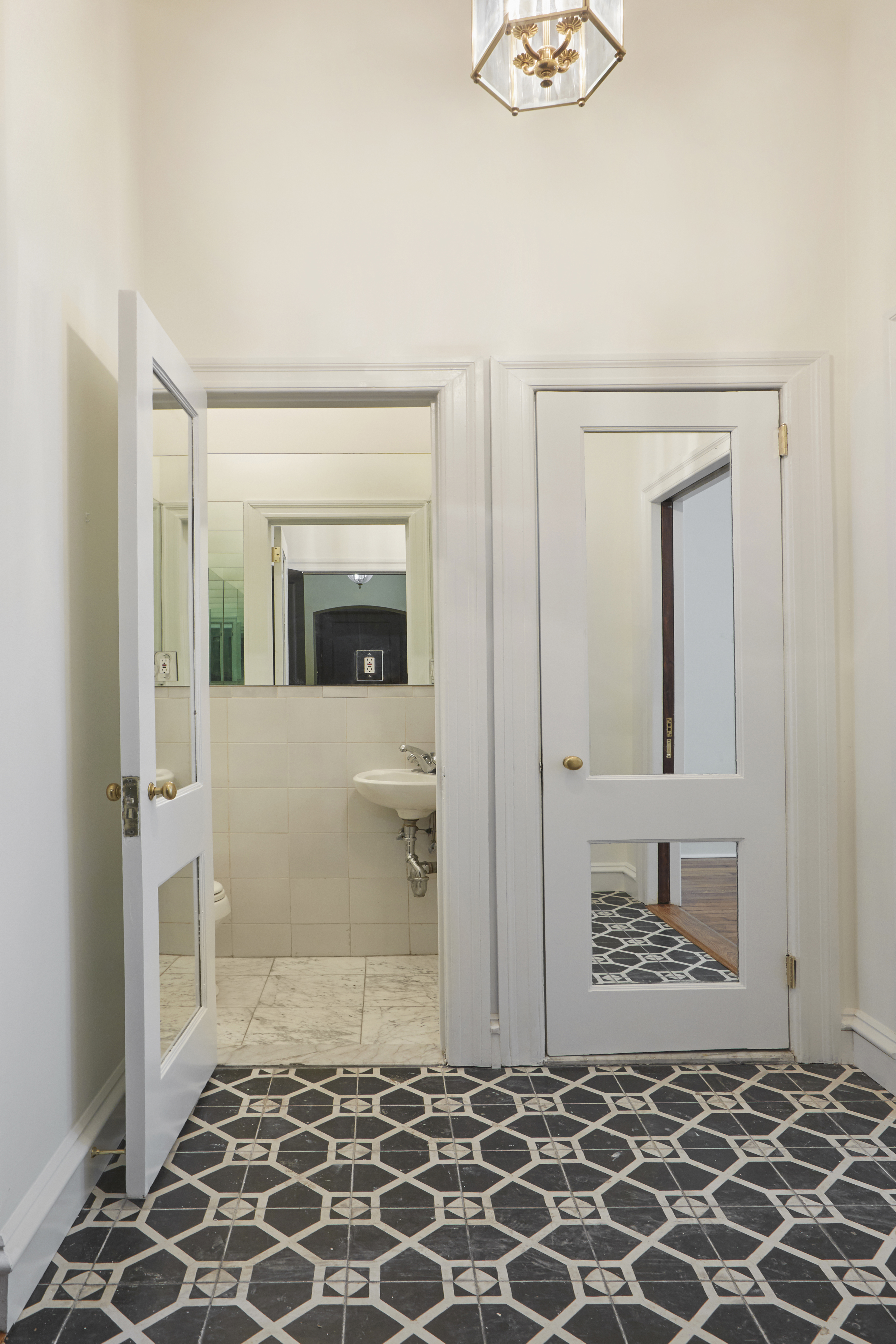 157 East 75th Street, Unit 1E Manhattan, NY 10021 - Photo 10 of 21 a view of a hallway with wooden floor and a living room