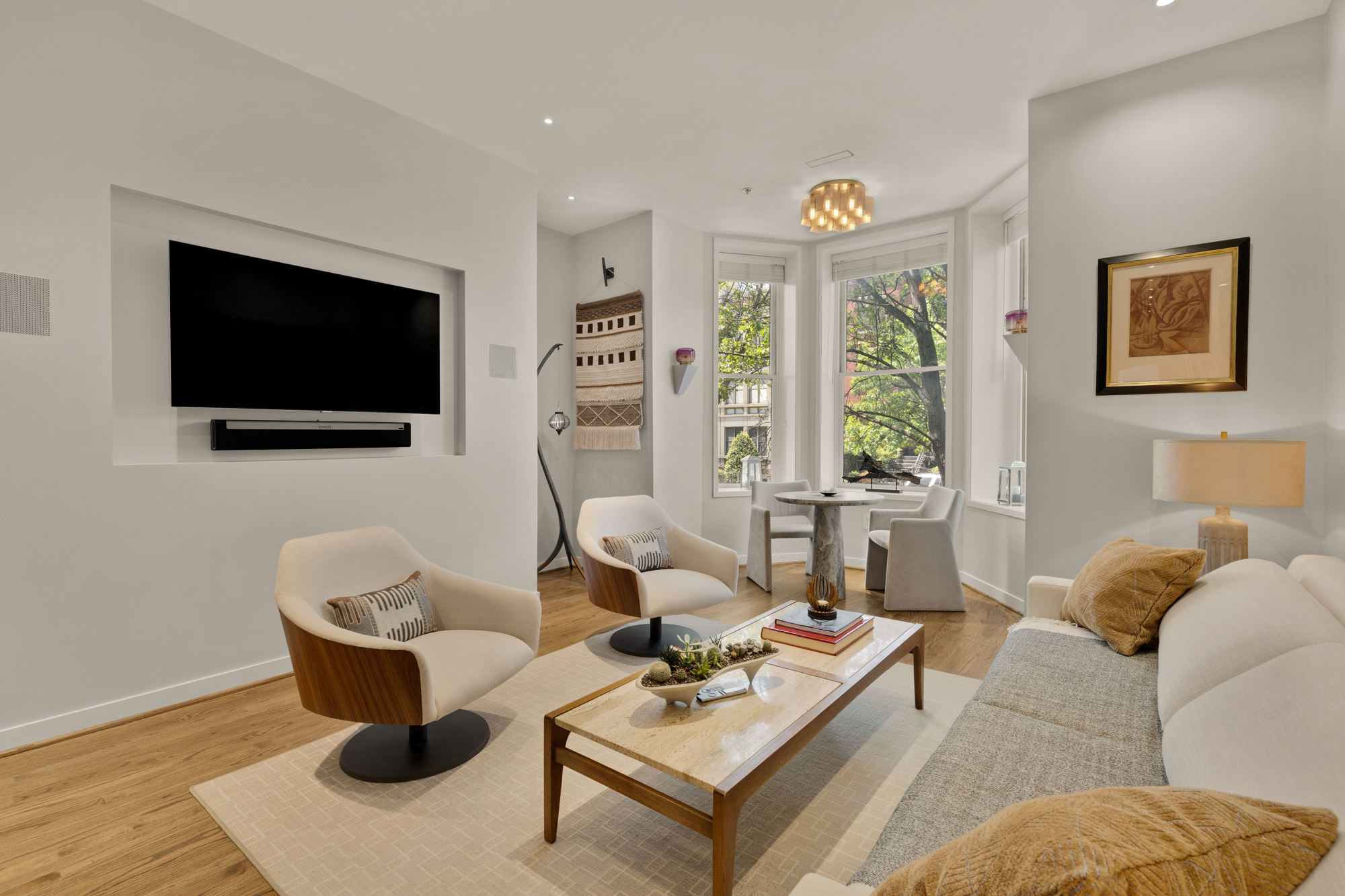 1407 15th Street Northwest, Unit 2 Washington, DC 20005 - Photo 10 of 24 a living room with furniture a flat screen tv and a floor to ceiling window