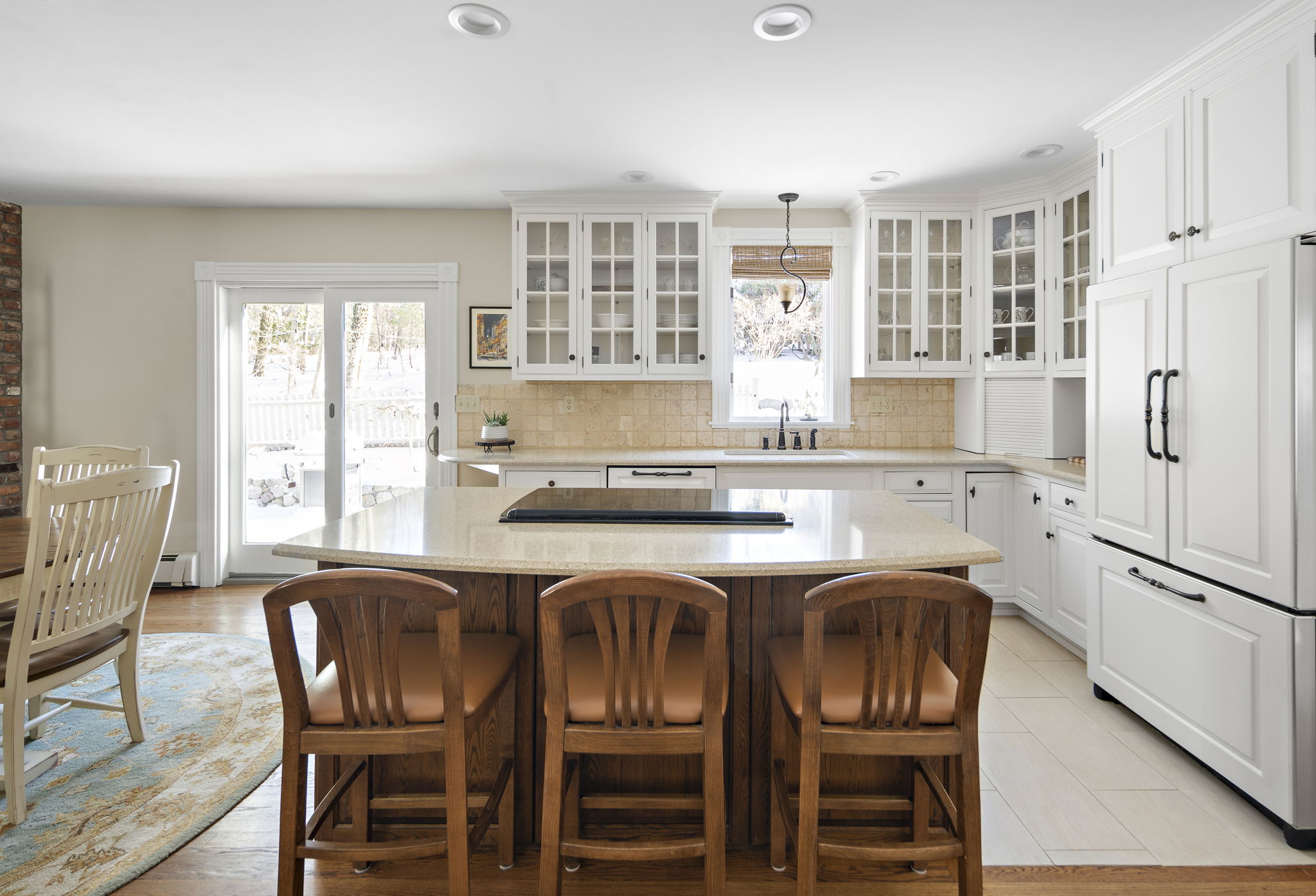 56 Jefferson Road Winchester, MA 01890 - Photo 8 of 26 a kitchen with stainless steel appliances granite countertop a stove a sink dishwasher a dining table and chairs