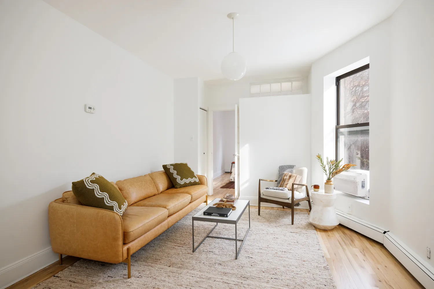 a living room with furniture and a rug